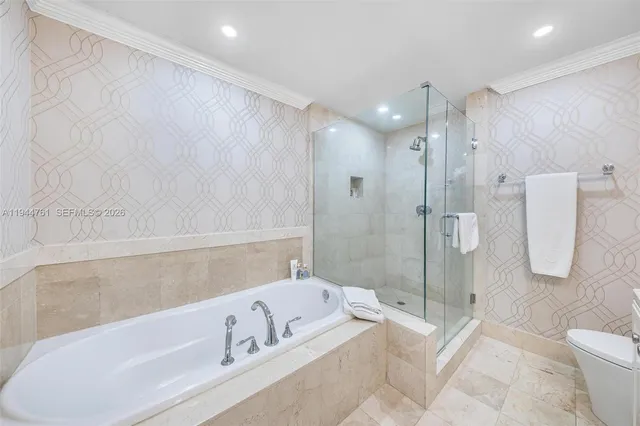 a bathroom with a granite countertop toilet a sink and shower