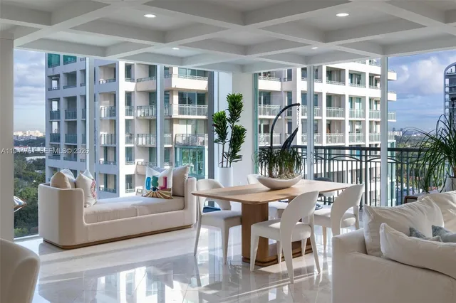 a living room with furniture and a floor to ceiling window