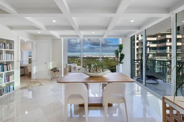 a view of a dining room with furniture and window
