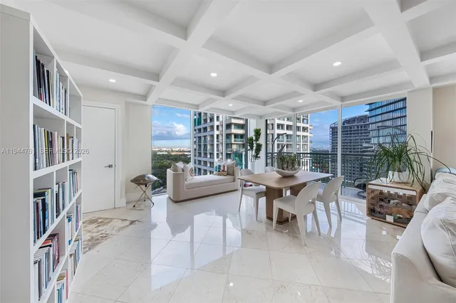 a dining room with furniture and a large window
