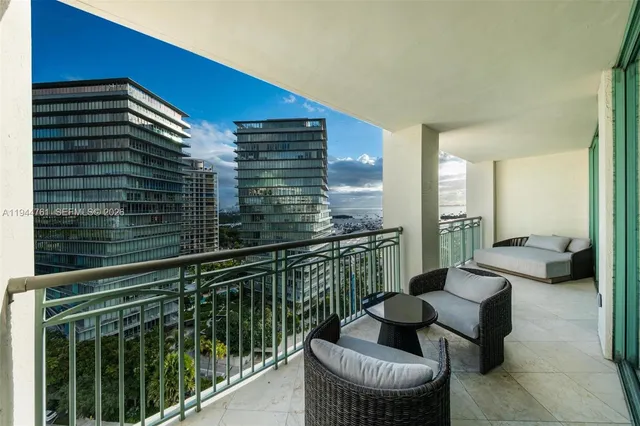 a balcony with couch and chairs