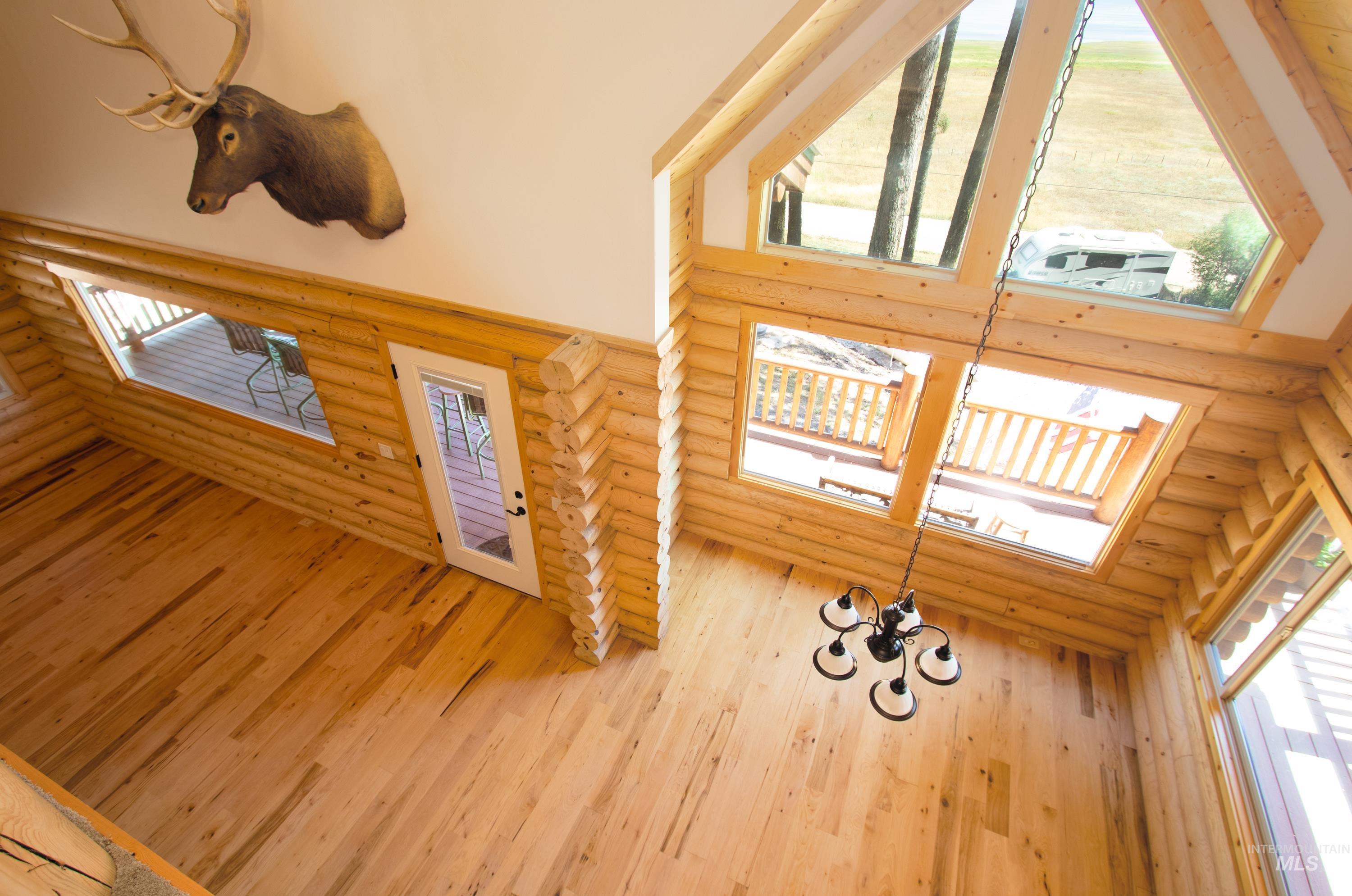 1539 West Mountain Road Cascade, ID 83611 - Photo 15 of 33 Foyer featuring rustic walls, a high ceiling, a skylight, and light wood finished floors