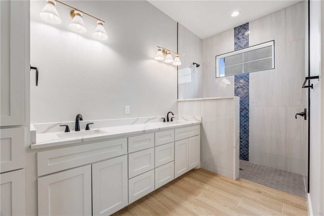 129 Frontside Drive Corpus Christi, TX 78373 - Photo 12 of 21 a spacious bathroom with a double vanity sink a mirror and shower