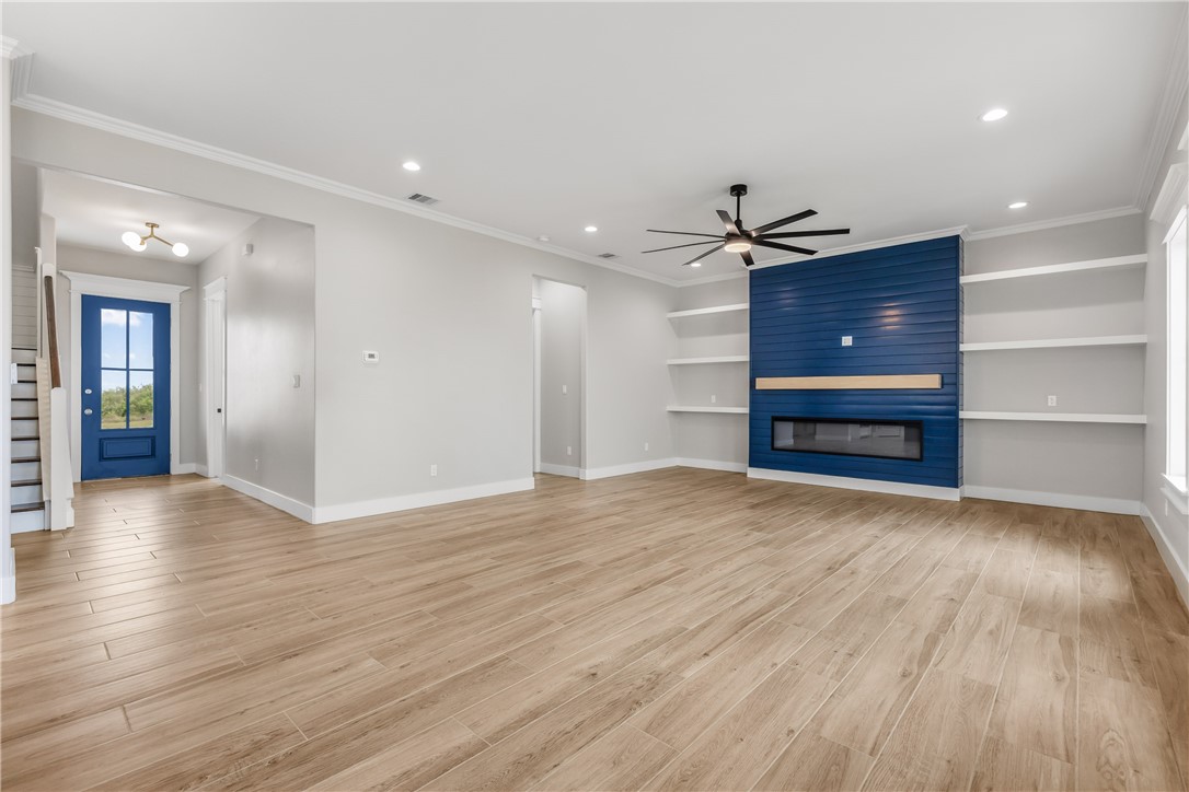 129 Frontside Drive Corpus Christi, TX 78373 - Photo 6 of 21 a view of empty room with wooden floor and kitchen