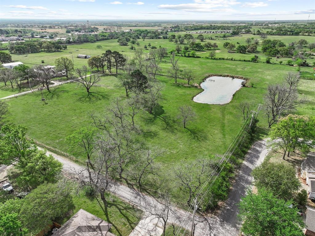 819 South Morrison Street Pilot Point, TX 76258 - Photo 12 of 12 a view of a lake with a yard