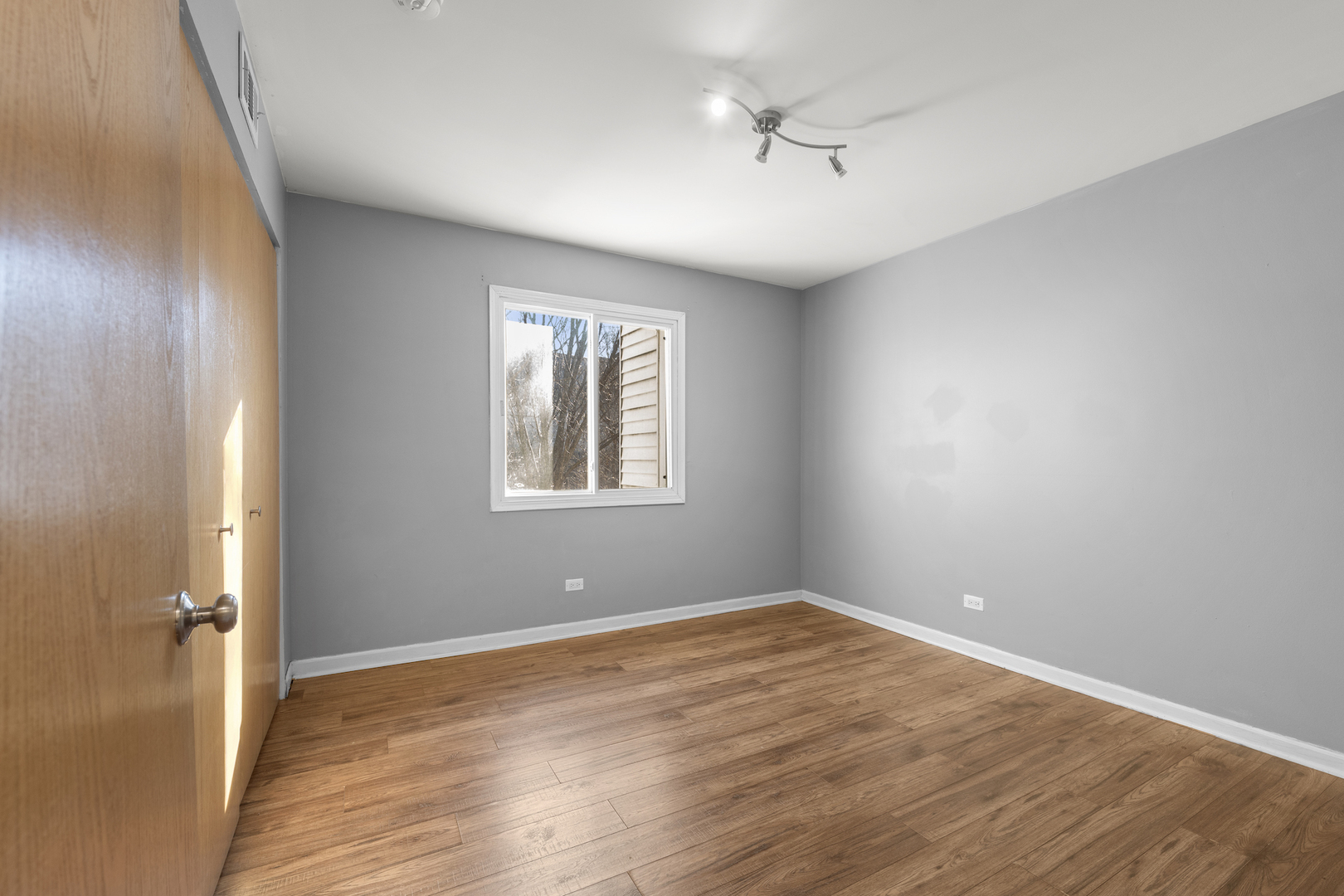 10440 Brooks Lane, Unit B4 Chicago Ridge, IL 60415 - Photo 12 of 14 a view of an empty room with a window and wooden floor