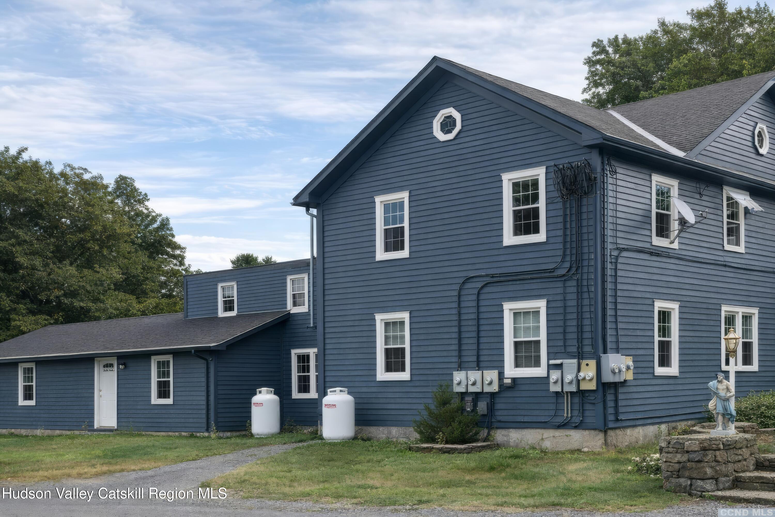 586 Old Rte 23 Cairo, NY 12405 - Photo 3 of 16 a front view of a house with a garden
