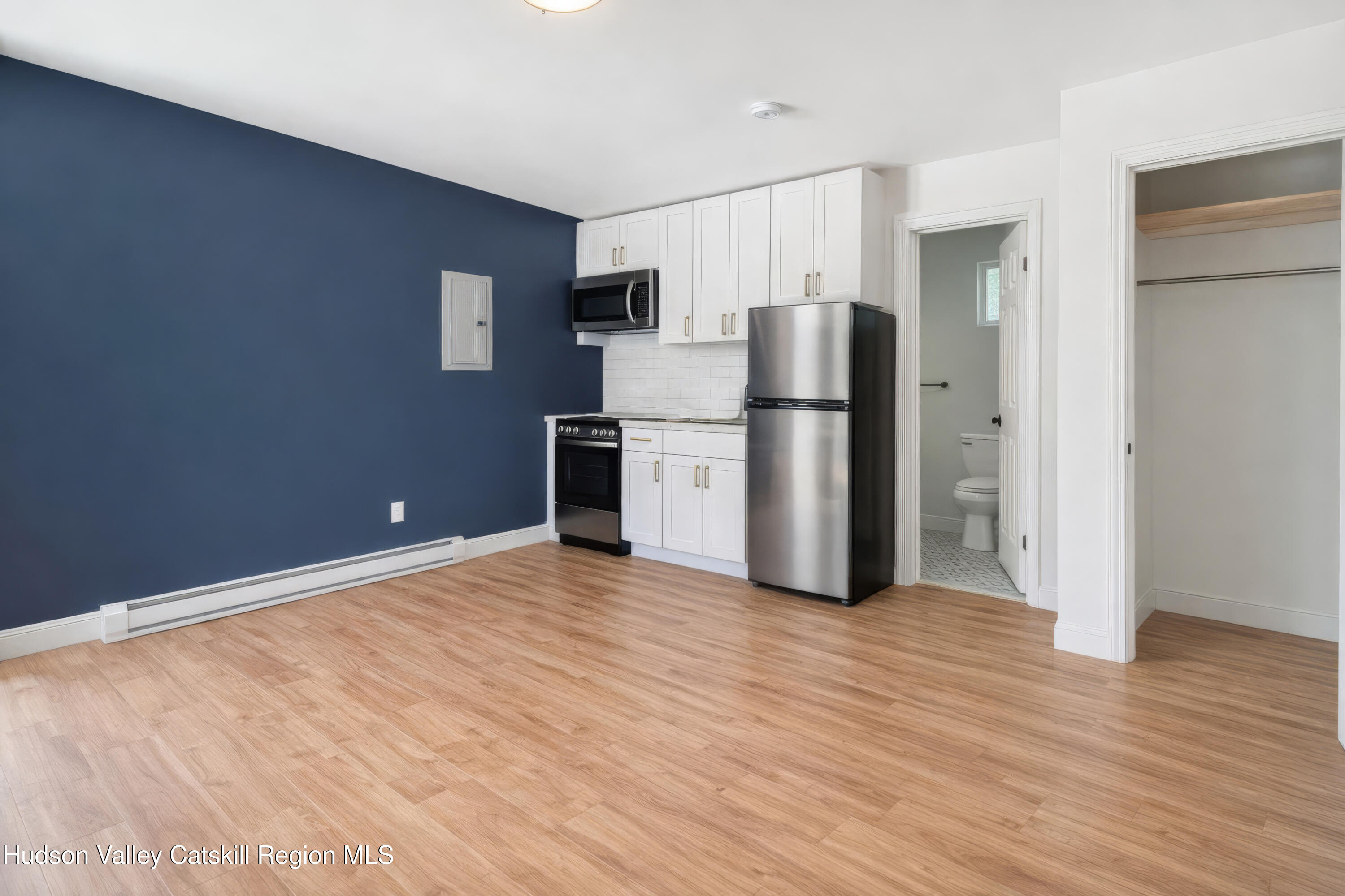 586 Old Rte 23 Cairo, NY 12405 - Photo 6 of 16 a view of kitchen with refrigerator cabinets and wooden floor