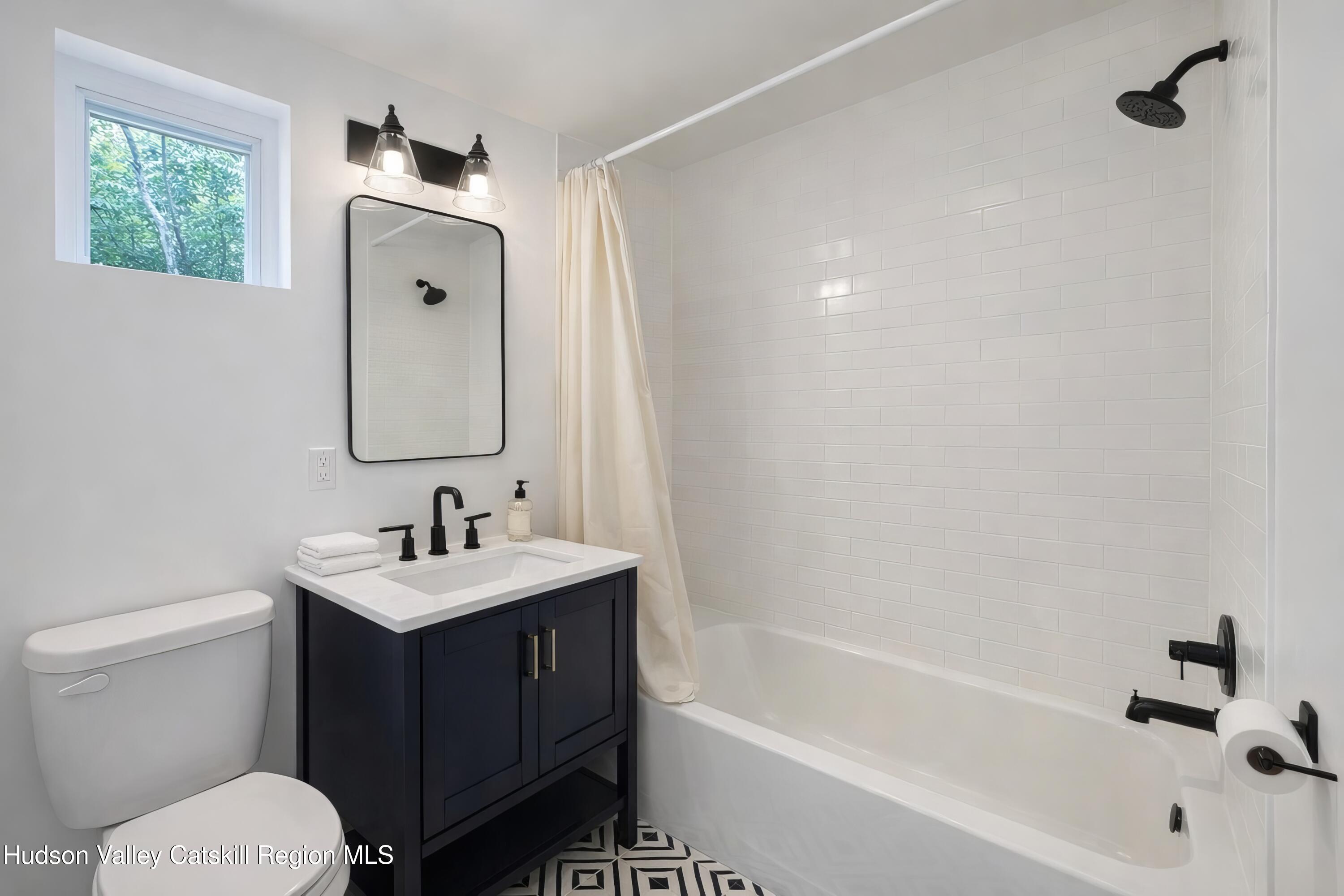 586 Old Rte 23 Cairo, NY 12405 - Photo 8 of 16 a bathroom with a sink a toilet and bathtub