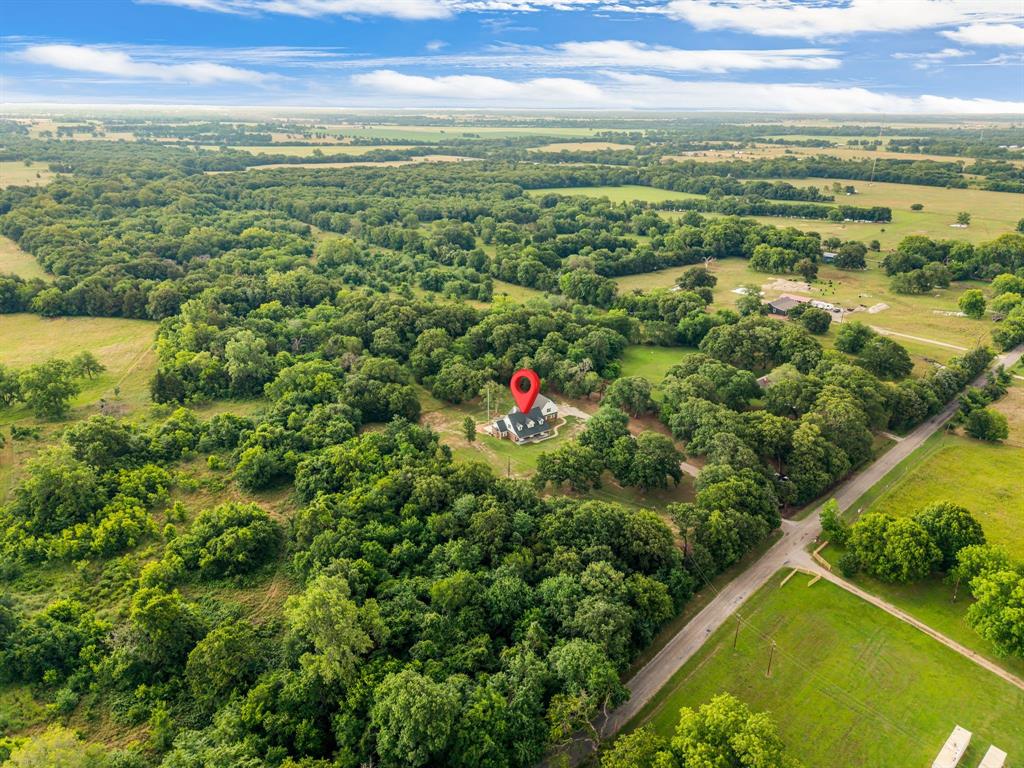 1037 Harrison Road Denison, TX 75021 - Photo 36 of 39 Expansive aerial view showcasing a property situated amidst abundant mature trees and natural greenery
