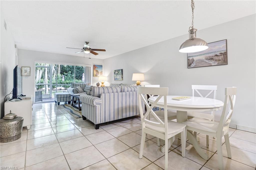 5675 Whitaker Road, Unit B101 Naples, FL 34112 - Photo 16 of 45 a living room with furniture and a chandelier