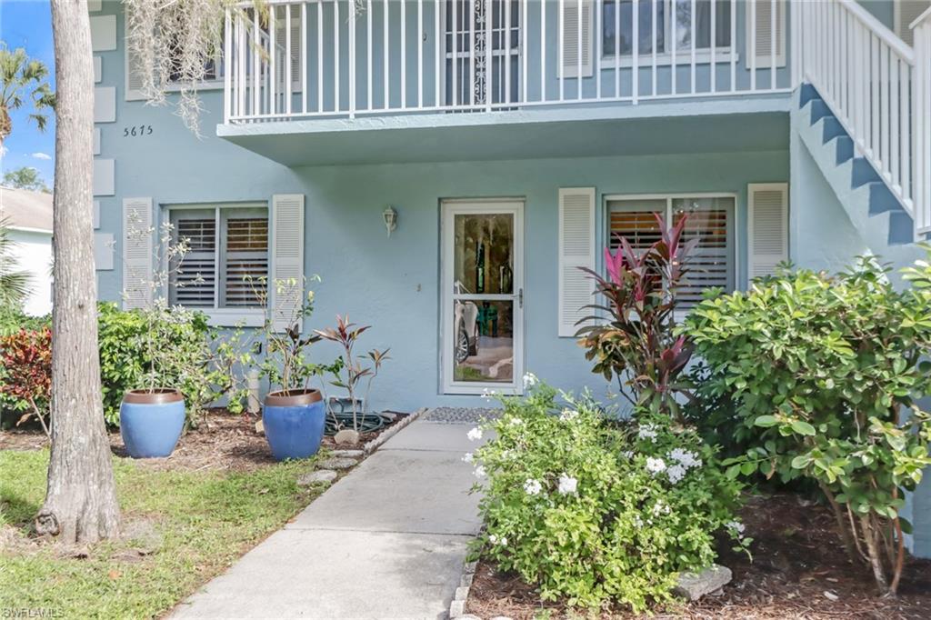 5675 Whitaker Road, Unit B101 Naples, FL 34112 - Photo 3 of 45 a front view of a house with potted plants