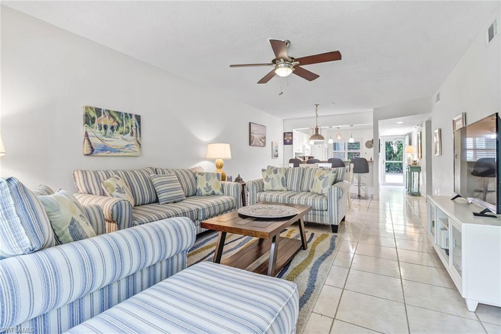 5675 Whitaker Road, Unit B101 Naples, FL 34112 - Photo 8 of 45 a living room with furniture and a view of kitchen