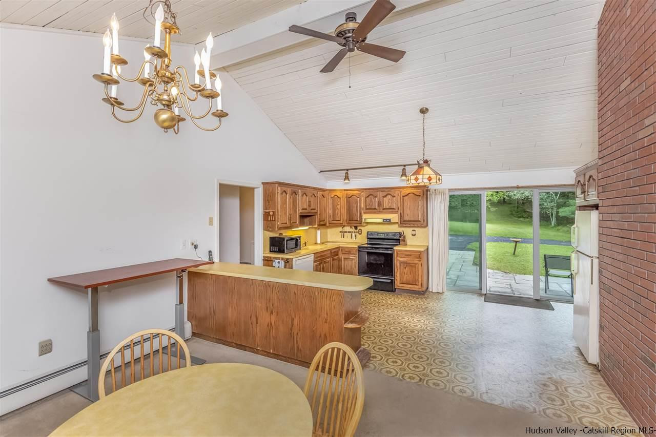 64 Buck Road Stone Ridge, NY 12484 - Photo 18 of 34 a dining room with furniture a chandelier and window