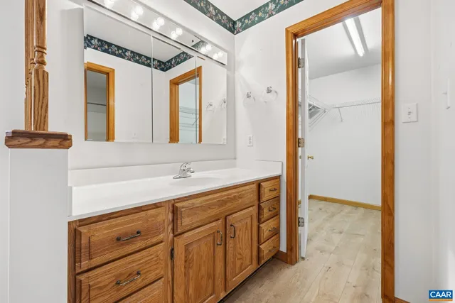 a bathroom with a sink a mirror and a shower
