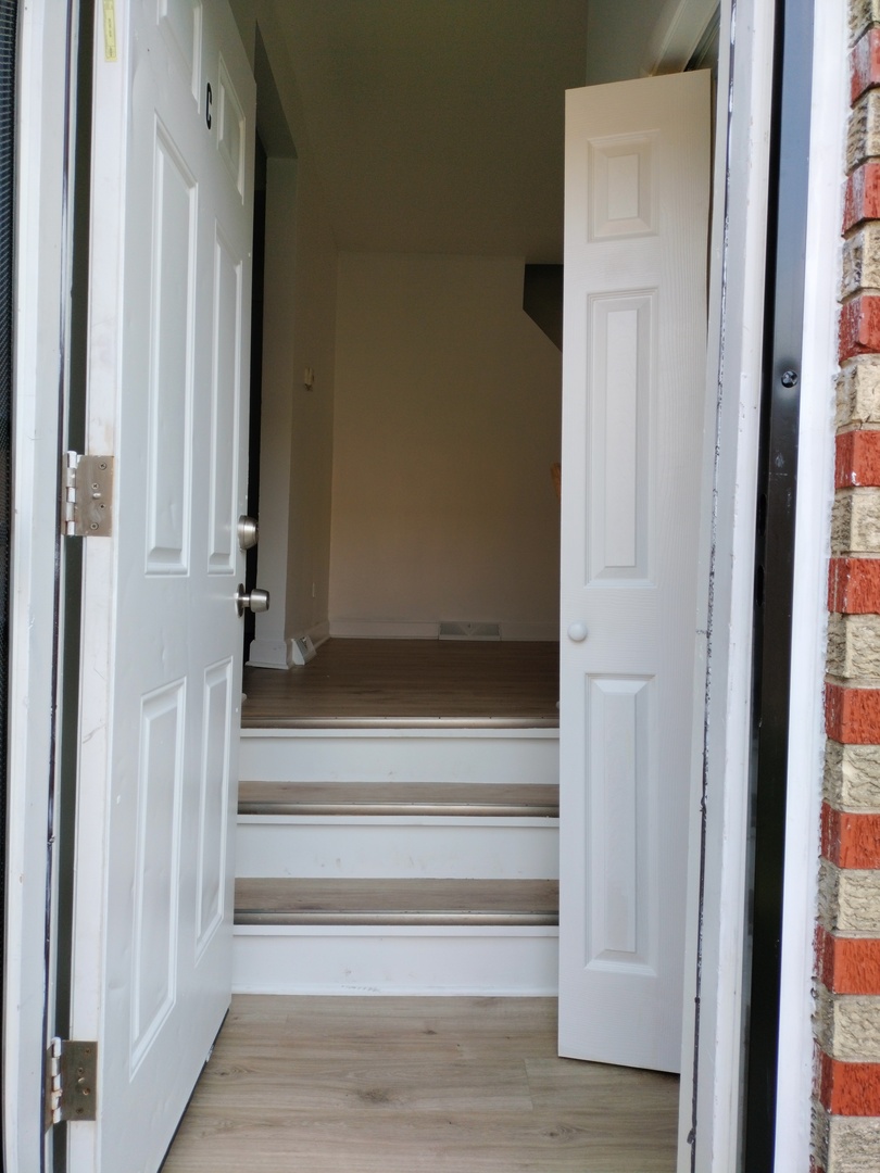 7910 South Muskegon Avenue, Unit 3 Chicago, IL 60617 - Photo 2 of 17 a view of entryway with wooden floor