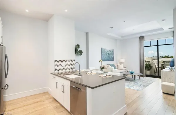 a large white kitchen with a large window