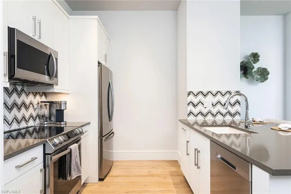 a kitchen with stainless steel appliances granite countertop a stove and a refrigerator