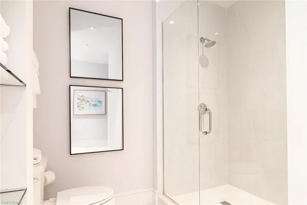 a bathroom with a toilet sink and shower