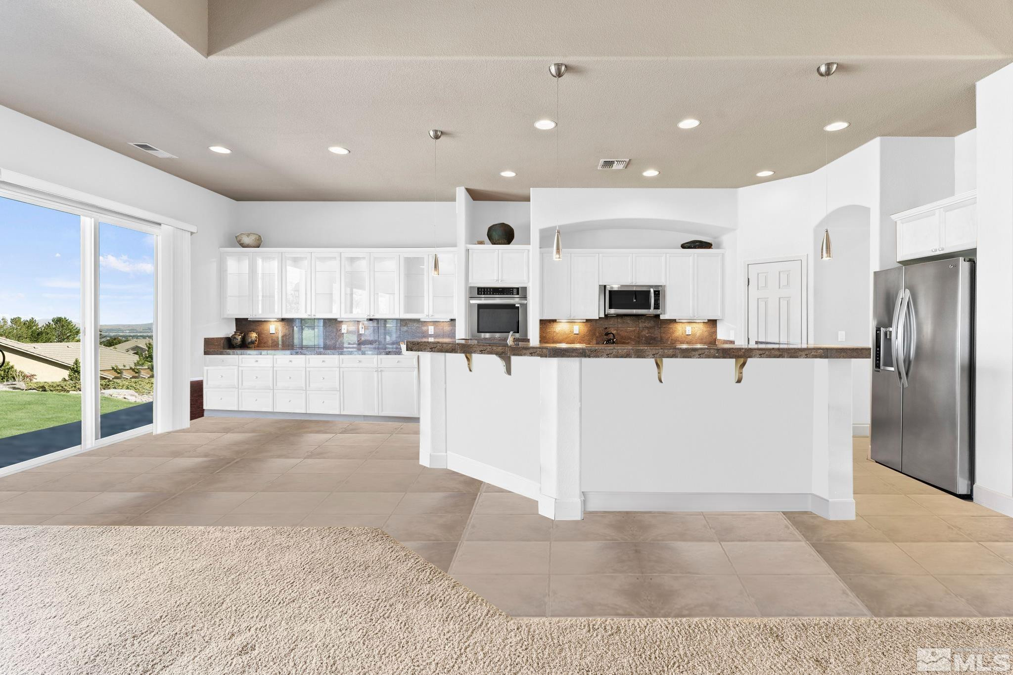 2155 Kingman Court Reno, NV 89511 - Photo 2 of 2 a view of kitchen with kitchen island a sink a center island stainless steel appliances and a cabinets