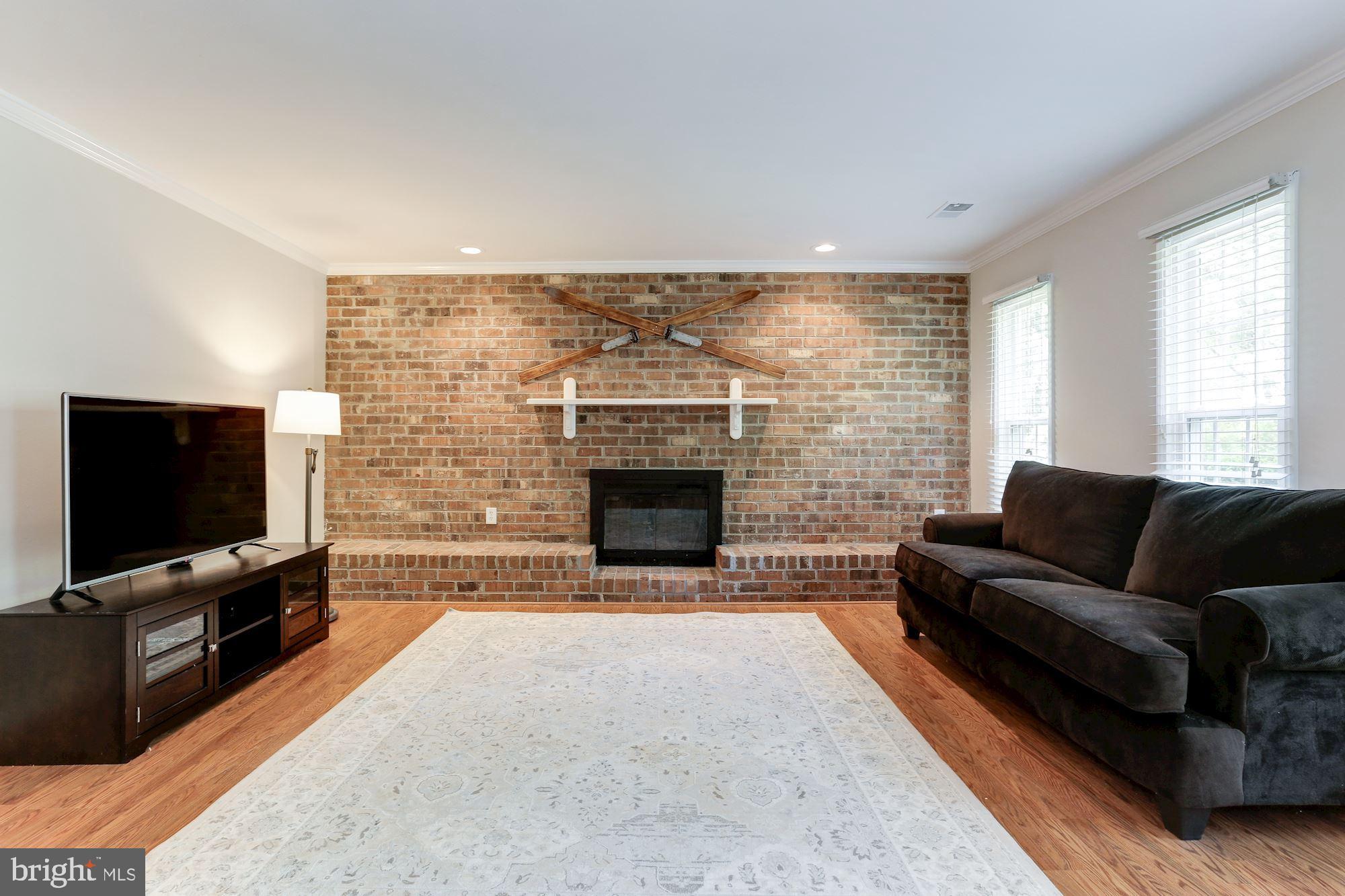 12335 Coleraine Court Reston, VA 20191 - Photo 44 of 84 Family Rm - Brick Wall/Fireplace are Focal Points