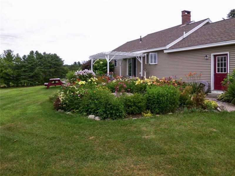 186 Hallowell Road Pownal, ME 04069 - Photo 22 of 25 Exterior Back. Landscaping in the...
