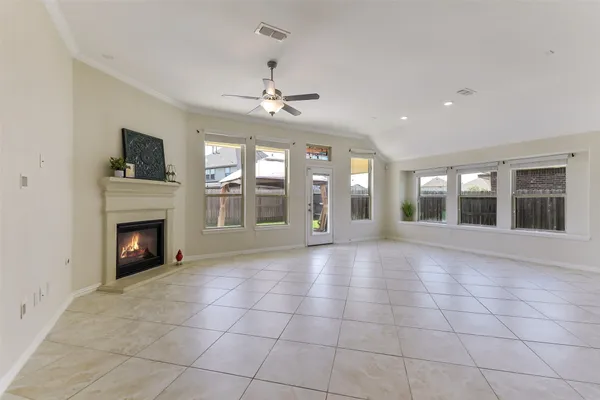 a view of an empty room with a fireplace and a window