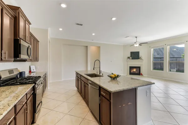 a kitchen that has a sink and a stove in it