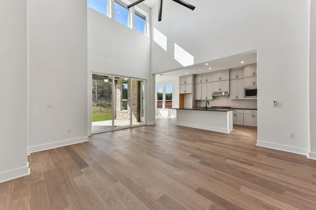 a view of a kitchen with wooden floor and a window