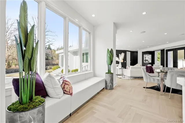 a living room with patio furniture and a large window