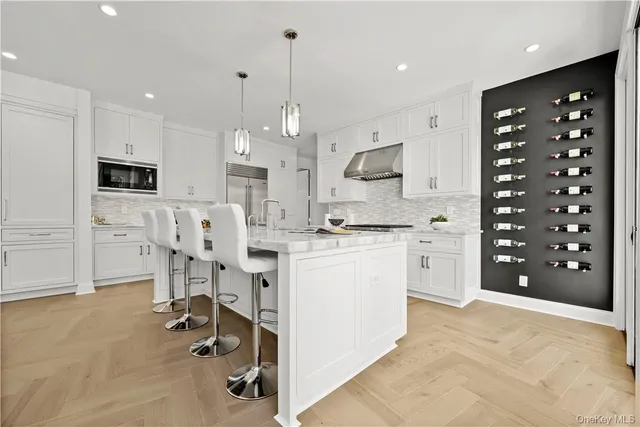 a kitchen with white cabinets and appliances