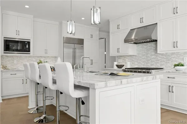 a kitchen with stainless steel appliances granite countertop a stove a sink dishwasher and a refrigerator