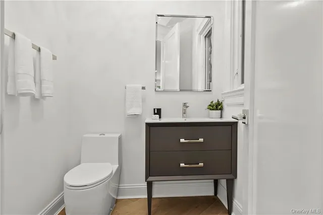 a bathroom with a toilet a sink and mirror