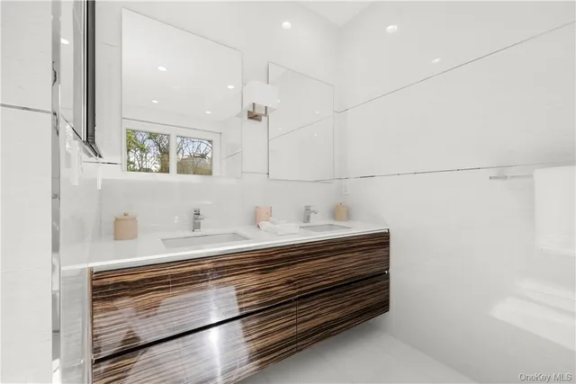 a white bath tub sitting next to a shower