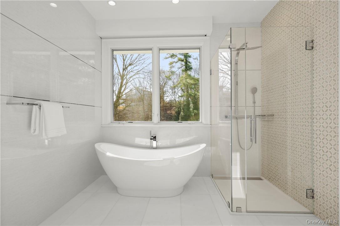 343 Purchase Street Rye, NY 10580 - Photo 29 of 36 a white bath tub sitting next to a shower