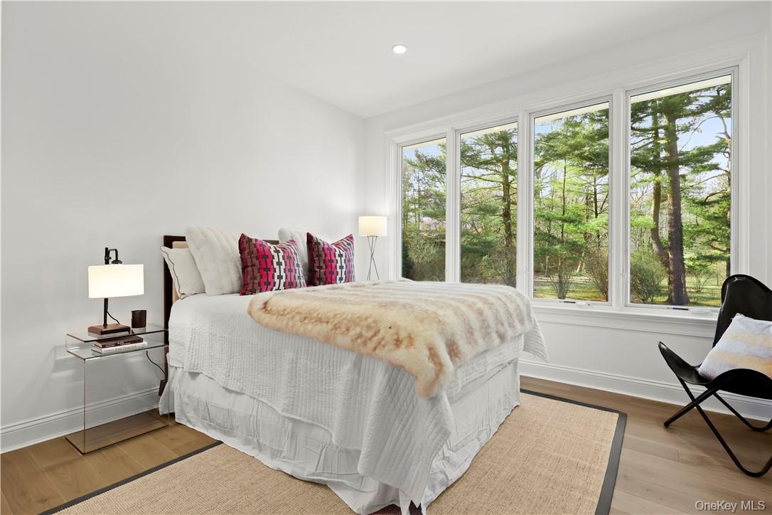 343 Purchase Street Rye, NY 10580 - Photo 30 of 36 a spacious bedroom with a bed and a large window