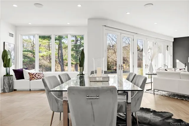a living room with furniture and floor to ceiling windows