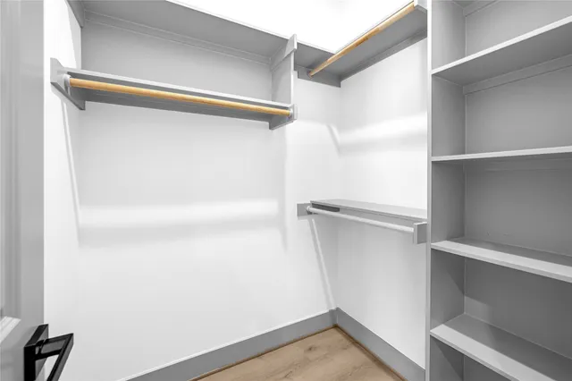 a view of walk in closet with empty racks