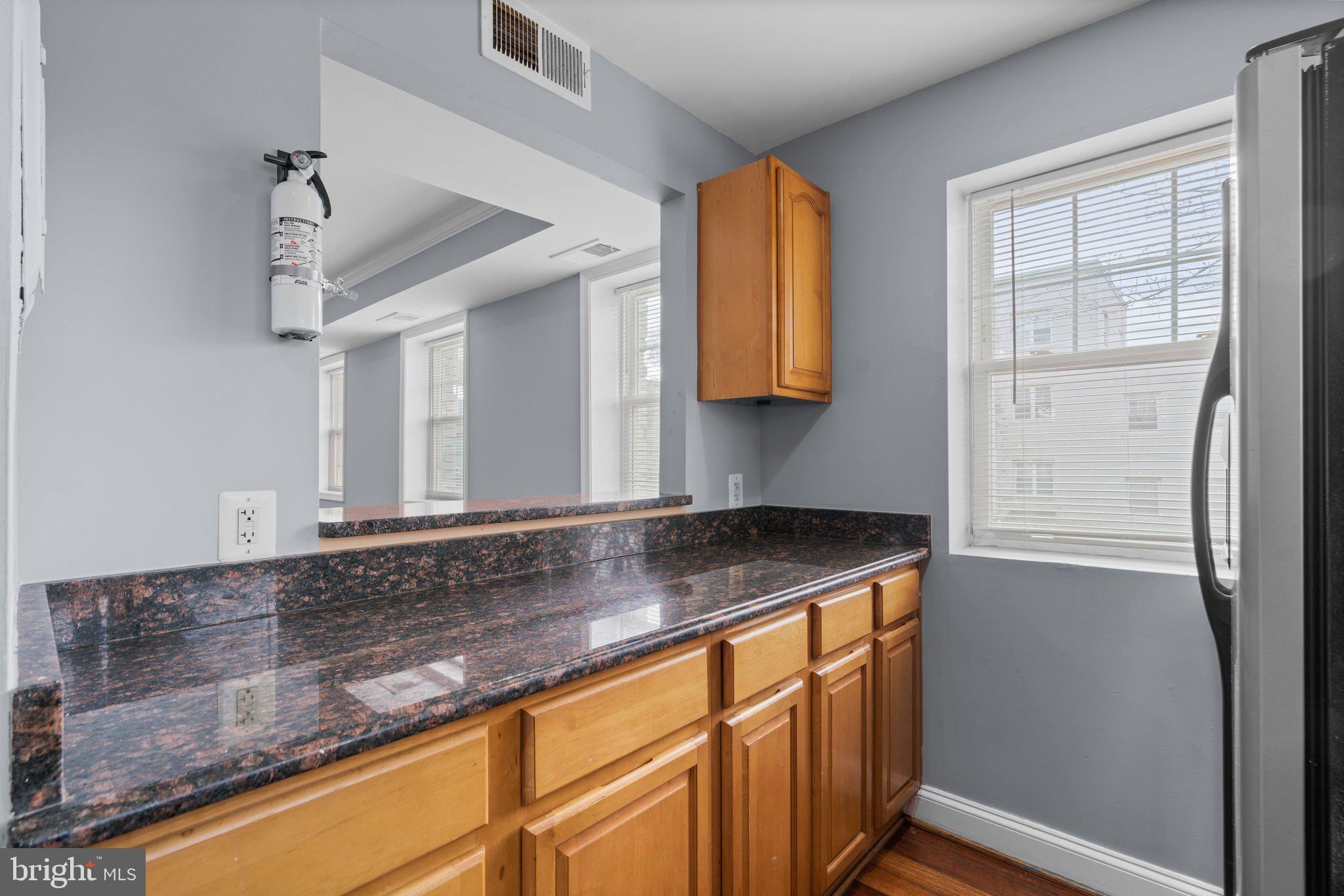3866 9th Street Southeast, Unit 101 Washington, DC 20032 - Photo 12 of 24 a kitchen with stainless steel appliances granite countertop a sink and a cabinets