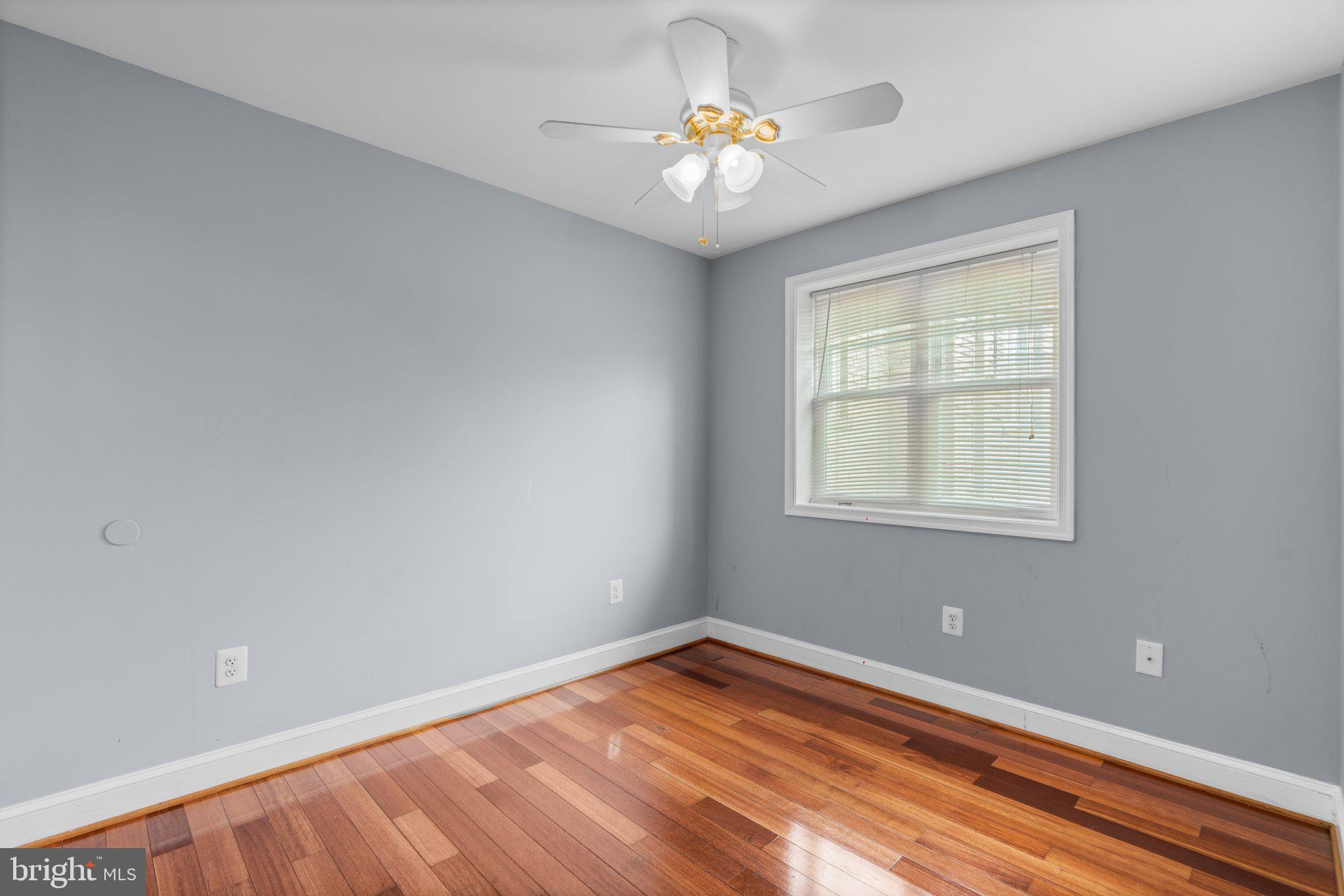 3866 9th Street Southeast, Unit 101 Washington, DC 20032 - Photo 13 of 24 wooden floor in an empty room with a window