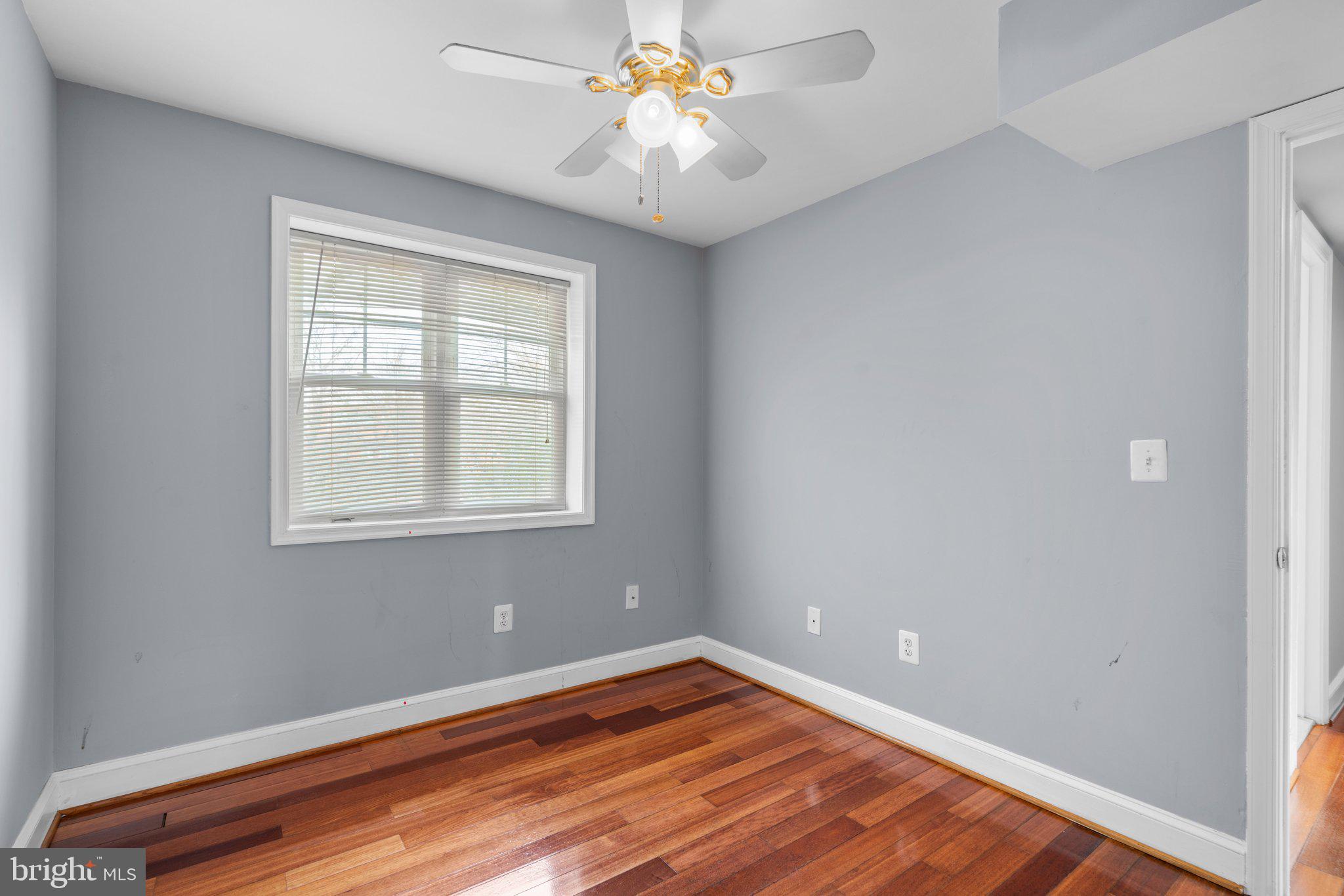 3866 9th Street Southeast, Unit 101 Washington, DC 20032 - Photo 14 of 24 a view of an empty room with window and wooden floor