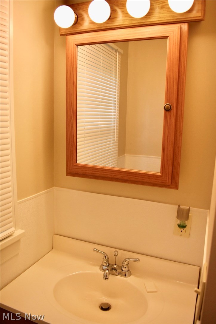 1246 Deforest Road Southeast Warren, OH 44484 - Photo 19 of 26 The single vanity has a new medicine cabinet with vanity lights overhead. Cabinet space is under the sink.