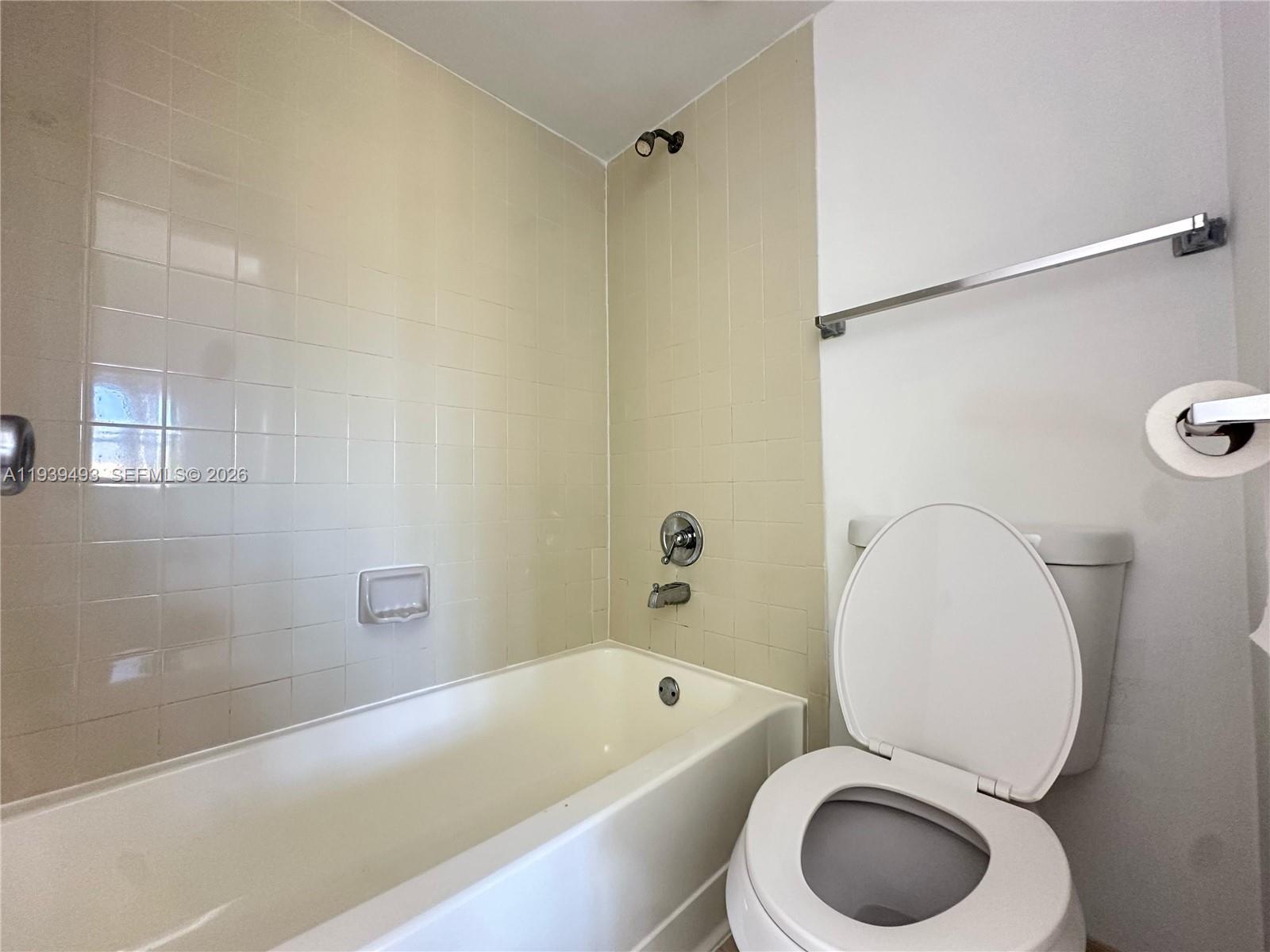 7195 Northwest 179th Street, Unit 209 Hialeah, FL 33015 - Photo 11 of 13 a bathroom with a toilet and a bathtub