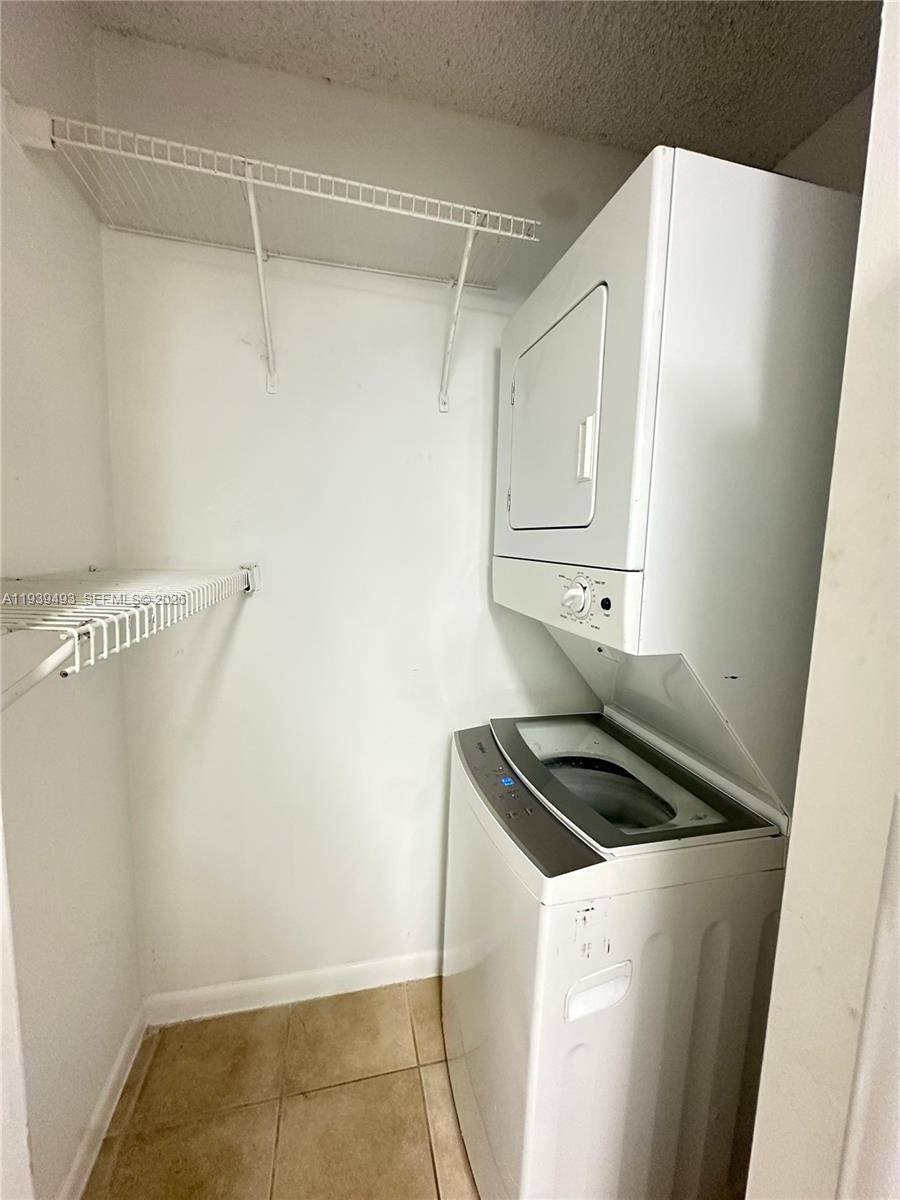 7195 Northwest 179th Street, Unit 209 Hialeah, FL 33015 - Photo 13 of 13 a kitchen with a refrigerator and cabinets