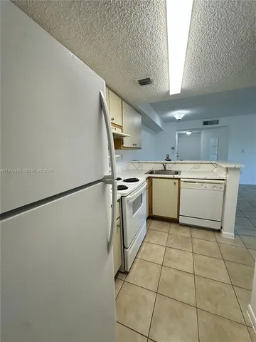 a kitchen with a cabinets window and stainless steel appliances