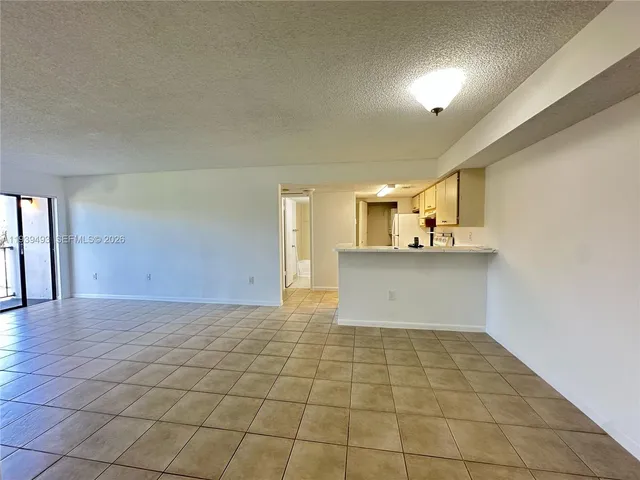 a view of a kitchen with a sink and a window