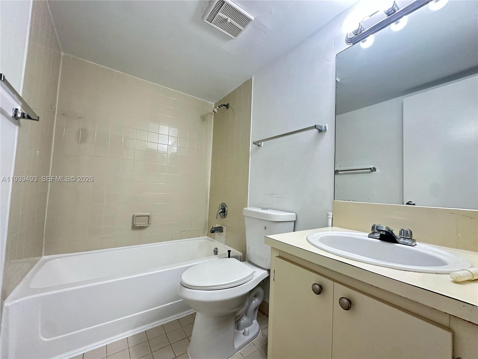 7195 Northwest 179th Street, Unit 209 Hialeah, FL 33015 - Photo 6 of 13 a bathroom with a sink a toilet and shower