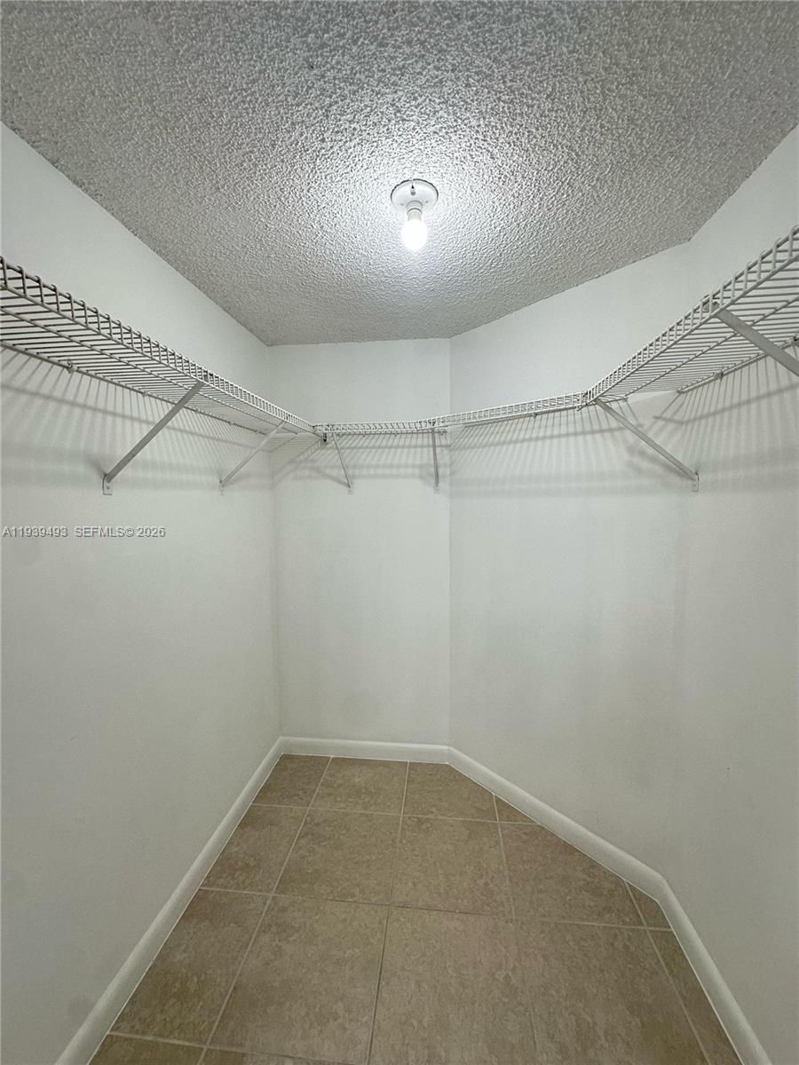 7195 Northwest 179th Street, Unit 209 Hialeah, FL 33015 - Photo 9 of 13 a view of a room with racks on the wall