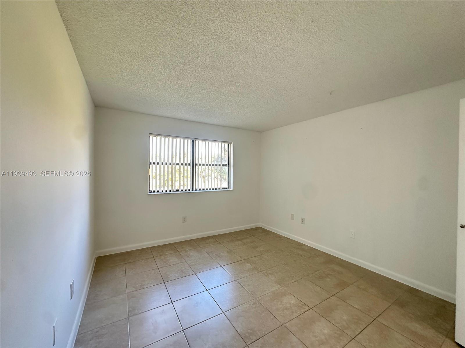 7195 Northwest 179th Street, Unit 209 Hialeah, FL 33015 - Photo 10 of 13 an empty room with a window
