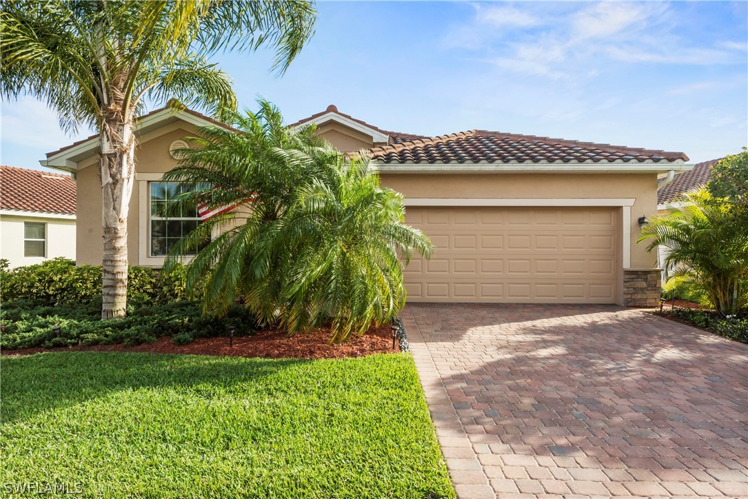 11680 Eros Road Lehigh Acres, FL 33971 - Photo 1 of 27 a view of a house with a yard and plants